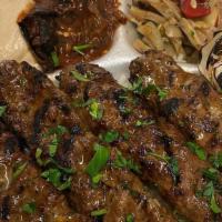 Kufta Kabob Plate · Two skewers of meat served with 4 side salads including hummus, regular salad, spicy eggplan...