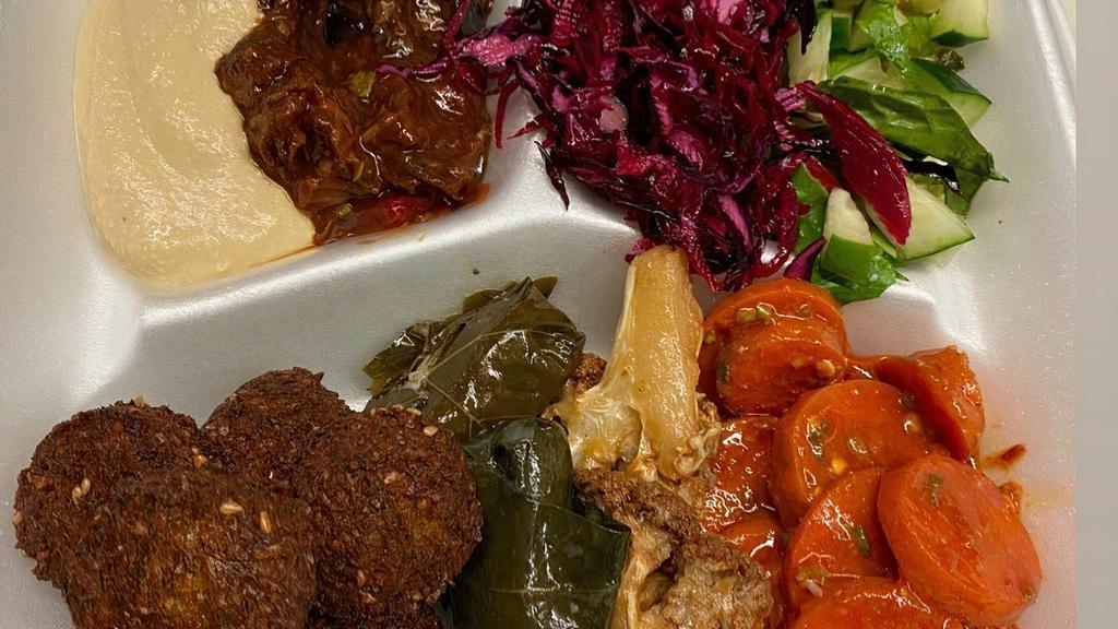 Falafel Plate · Served with 4 side salads including hummus, regular salad, spicy eggplant salad or spicy Turkish salad, stuffed grape leaves, pita bread on the side.