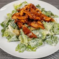 Buffalo Chicken Caesar Salad · Homemade Caesar salad topped with spicy buffalo chicken cutlet.