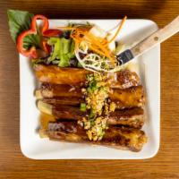 Marinated Thai Short Spare Ribs · Double-cooked tender ribs, short cut and served with a special Thai herb sauce.
