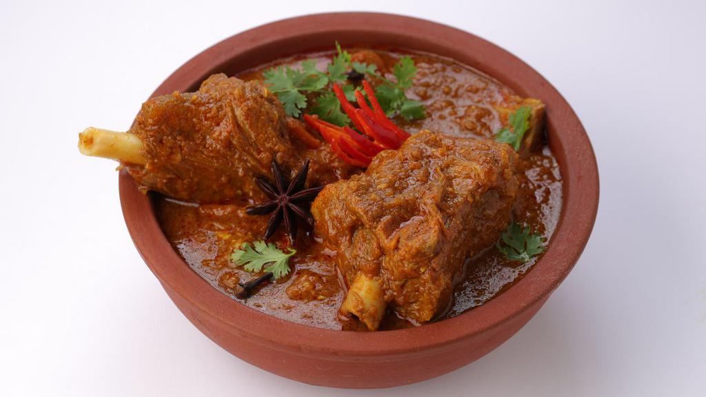 Curry Goat · A flavorful, traditional dish made of juicy goat meat, seasoned with Jamaican curry powder, fresh herbs and spices, cooked until deliciously tender. Served with your choice of two sides.