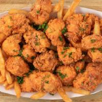 Large Crunchy Poppers Basket (16 Pc) · 16 chicken poppers with your choice of three sauces and either classic or cajun fries.