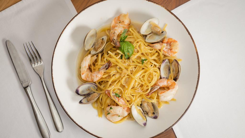 Shrimp Scampi With Clams · Large, wild-caught shrimp, and clams in shell prepared in scampi sauce (garlic, butter and oil) and served over a bed of linguine.