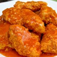 Crispy Boneless Wings · Crispy Boneless Chicken Wings tossed in sauce and served with fresh carrot & celery sticks a...