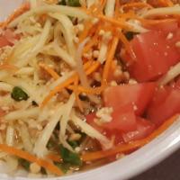 Som Tum Esan (Papaya Salad) · Thai green papaya salad mixed with string beans, tomatoes, chili, lime juice, and ground pea...