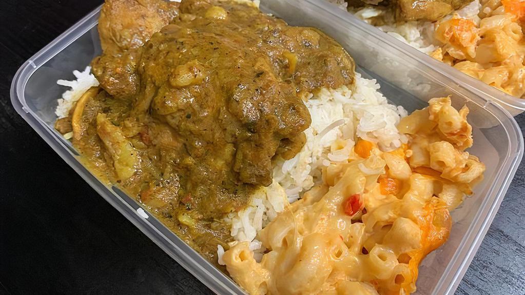 Curried Chicken · Chicken in a medium curry sauce served over Rice & Peas or Basmati Rice; Steamed Cabbage; tomato/cucumber
