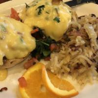 Eggs Benedict Florentine · Two poached eggs with sautéed spinach, Canadian bacon and tomato on an English muffin topped...