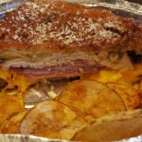 Monte Cristo · Ham, turkey, swiss and cheddar cheese with mustard and mayo batter dipped served with raspbe...