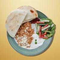 Spiced Chicken Plate · Served over rice and cucumber salad with pita bread, a side of tahini sauce, and a side of h...