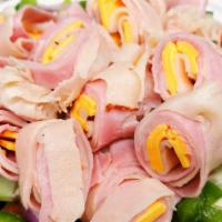 Chef Salad · Turkey and ham rolled with American cheese, over lettuce, tomatoes, cucumber, onion and gree...