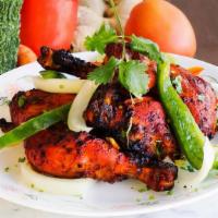 Tandoori Chicken (2 Pcs) With Naan · Chicken marinated in mild spices, grilled on a skewer.