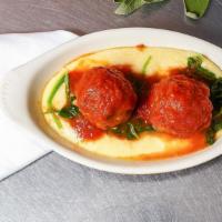 Polpette Alla Lucana (Piamonte) · Veal meatballs braised in tomato sauce over soft polenta with wilted spinach.