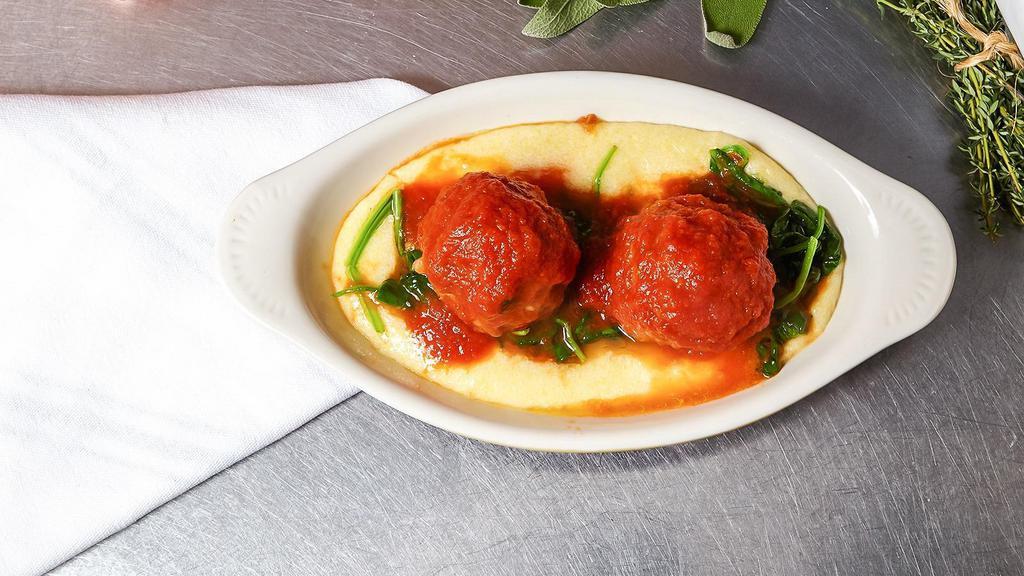 Polpette Alla Lucana (Piamonte) · Veal meatballs braised in tomato sauce over soft polenta with wilted spinach.