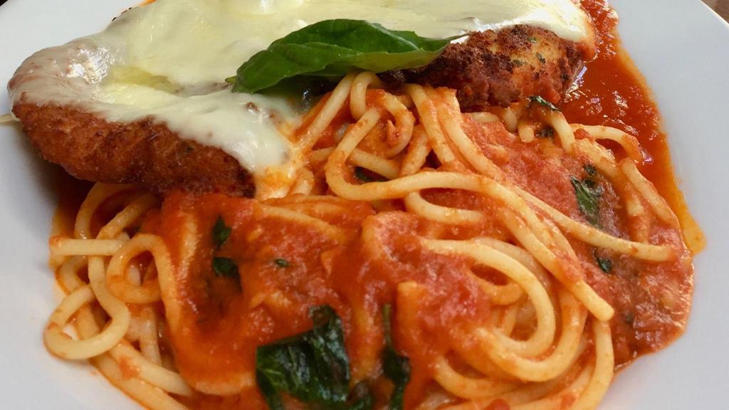 Chicken Parmigiana (Argentina) · Chicken breast topped with tomato sauce and mozzarella served with spaghetti.