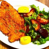 Chicken Milanese (Argentina) · Breaded chicken breast cutlet served with tomato and arugula salad.