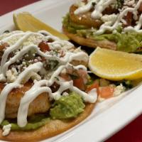 Shrimp Tostadas · Grilled jumbo shrimp, crispy tortillas, salad, guacamole, pico, sour cream, & queso fresco.