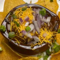Texas Style Chili  · House made with brisket, red & black beans and secrets spices topped with cheddar, red onion...