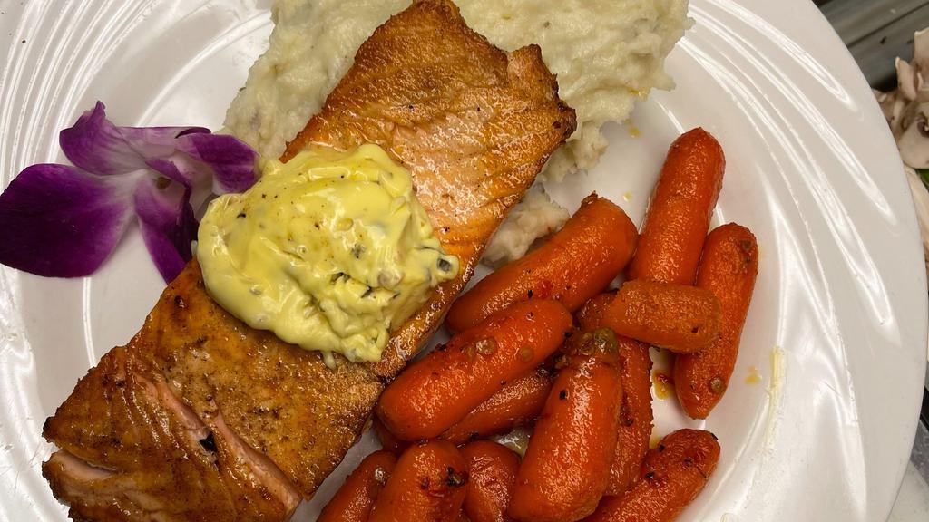 Skillet Seared Atlantic Salmon · Skillet seared center cut salmon filet, topped with herb garlic butter served with country mash potatoes and vegetable du jour.