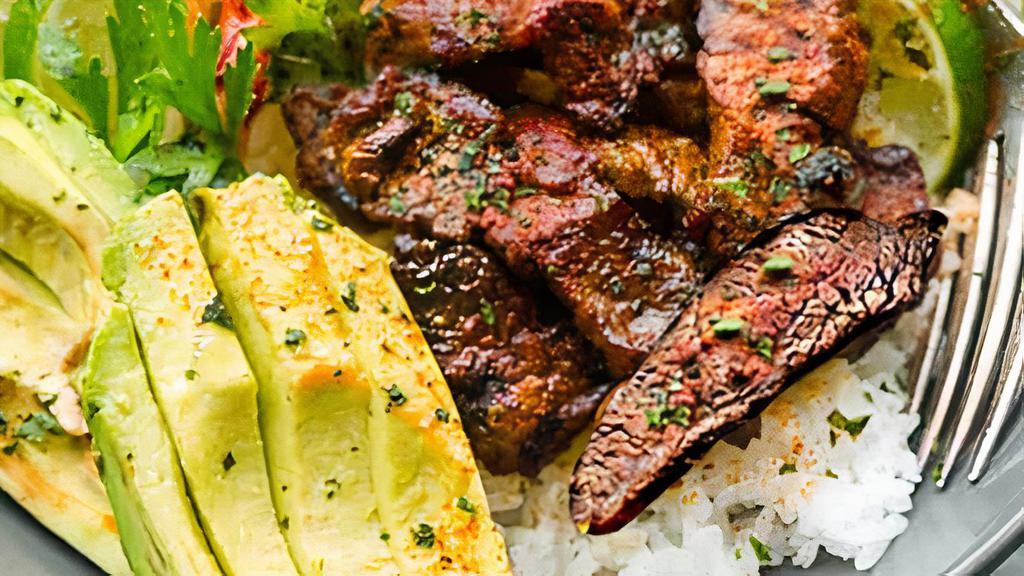 Chipotle Steak Avocado Rice Bowl · Chipotle steak avocado rice bowls are made with a tender juicy steak, bell peppers, corn, avocado and black beans over a bed of lime rice.
