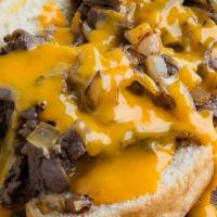 Signature Philly Cheese Steak · Shaved, sautéed ribeye with sautéed mushrooms, green peppers, caramelized onions and melted ...