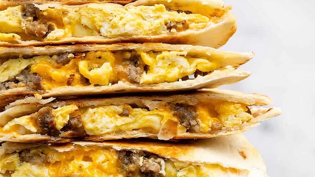 Breakfast Quesadilla · Flour tortillas stuffed with 2 scrambled eggs, melted cheese, peppers & onions, hot salsa and your choice of Sausage, ham or bacon