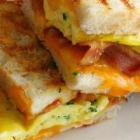 Bacon Egg & Cheese Panini Sandwich · Two eggs scrambled, bacon and grilled cheese.