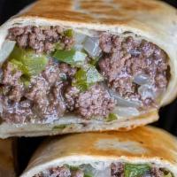 Philly Cheesesteak Wrap · Tender sliced beef, sautéed green peppers, caramelized onions and melted cheese on a wrap.