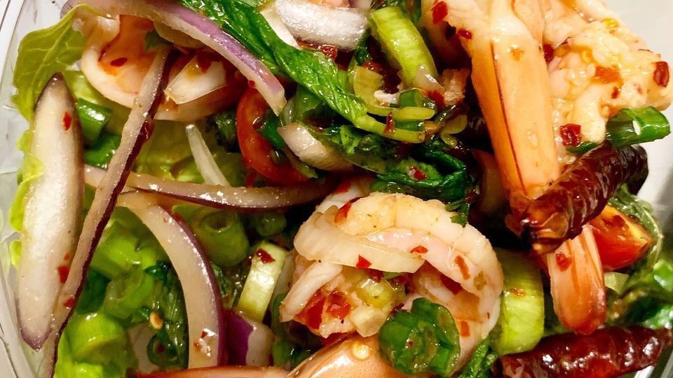 Plah Kung (Shrimp Salad) · Cooked shrimp with shallot, scallion, chili, Thai chili paste, and mint in spicy lime juice dressing.