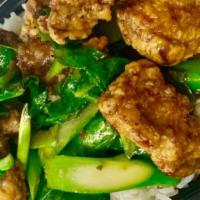 Ka Na Moo Krob Over Rice · Sautéed Crispy Pork Belly with Chinese broccoli, garlic, and fresh chili in brown thai garli...
