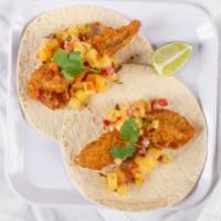 Baja Fish Taco Special · soft corn tortillas, lettuce, habanero salsa, and pineapple salsa.