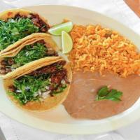 Create Your Own Tacos · Three tacos with filling, beans, and toppings.
