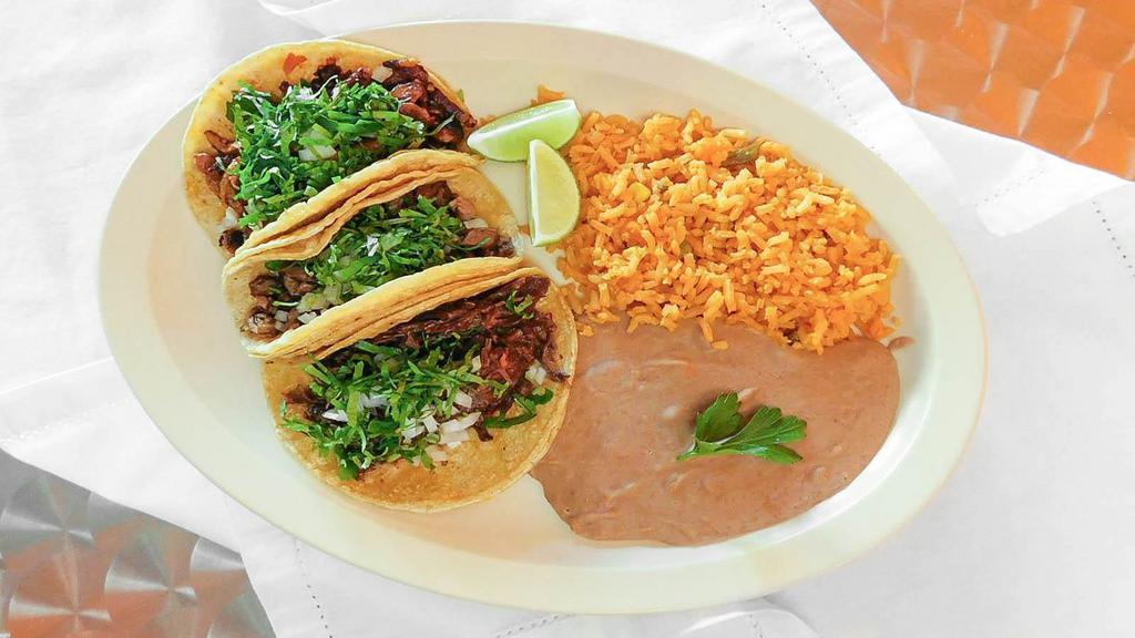 Create Your Own Tacos · Three tacos with filling, beans, and toppings.