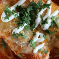Enchilada · Rolled in corn tortillas topped with cheese, sour cream, and cilantro. Served with rice and ...
