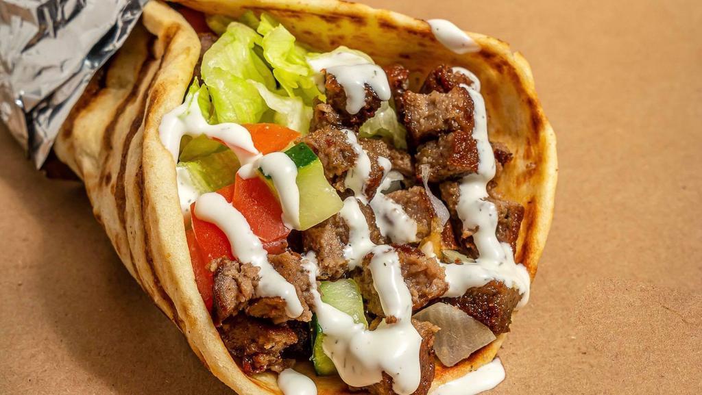 Lamb Gyro · Grilled Lamb served on pita with choice of salad and any of shahs sauces
