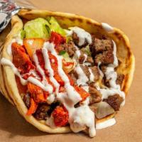Combo Gyro · Chicken and lamb gyro meat marinated and grilled to perfection served on a fresh pita- toppe...