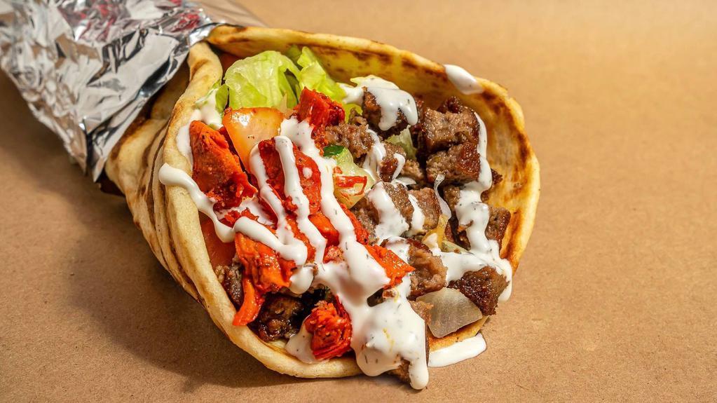 Combo Gyro · Chicken and lamb gyro meat marinated and grilled to perfection served on a fresh pita- topped with lettuce, and your choice of white, hot, green and bbq sauce