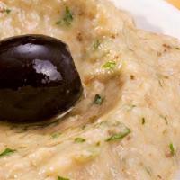 Hummus · Mashed chickpeas blended with fresh garlic, tahini, and herbs.