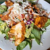 Tostada Salad · Black beans, Monterey Jack, queso fresco, guacamole and farm greens in a roasted jalapeno-li...