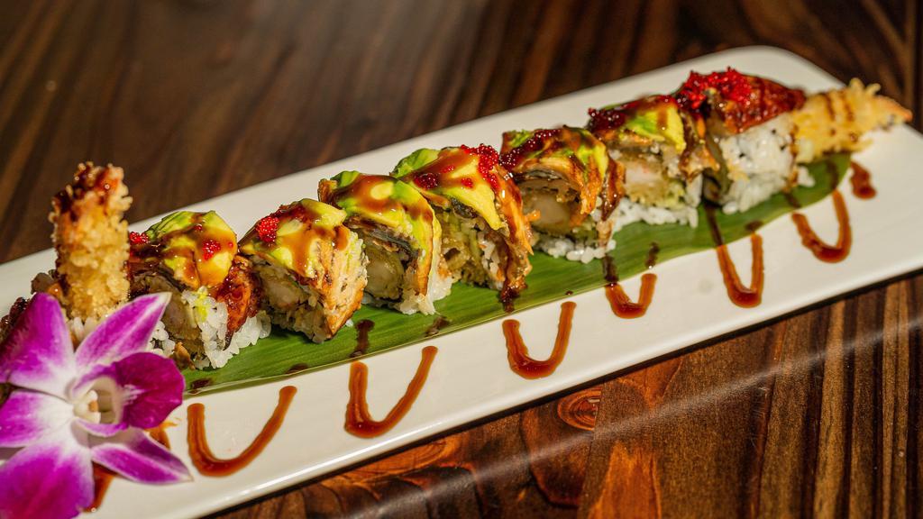 Dinosaur Roll · Shrimp tempura and cucumber topped with eel avocado in eel sauce and tobiko.