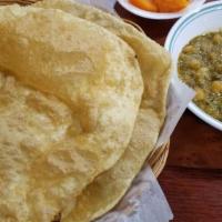 Halwa Puri · A delicious combination of sweet halwa, spicy chickpeas, and crunchy puri.
