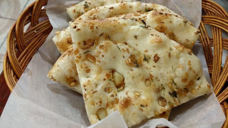 Garlic Naan · White flour bread, filled with chopped garlic and spices, cooked in tandoor.