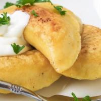 Perogies App · 4 pieces. Filled with potato and cream cheese. Served with a side of Sour cream.