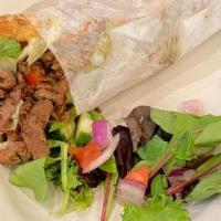 Lamb Shawarma Pita · Marinated minced meat with Lettuce, tomatoes, onions, pickles, parsley & sesame seed tahini ...
