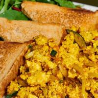 Vegan Scrambled Eggs · Organic tofu, turmeric, onion, tomato, whole wheat toast and side salad. Vegan.
