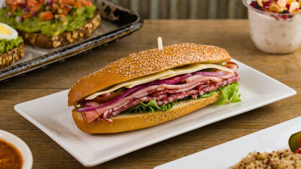 Italian Submarine · Smoked Ham, Genoa Salami, Provolone Cheese, Red Onions, Hot Peppers, Lettuce, Extra Virgin Olive Oil & Red Wine Vinegar on Sesame Hero.