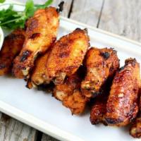 Chicken Wings · Eight breaded chicken wings done with the sauce of your liking.