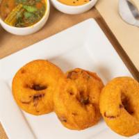 Medhu Vada · Fried lentil donuts served with coconut chutney and sambar.
