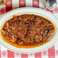 Ropa Vieja · Shredded flank steak simmered in tomato sauce with onions and peppers.