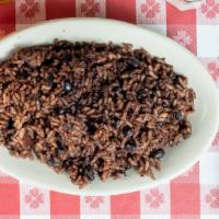 Moros Y Cristianos · Rice and beans cooked together with bacon.