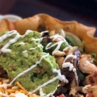Taco Salad · Mixed green salad with ground beef, shredded chicken or shredded beef, served with guacamole...